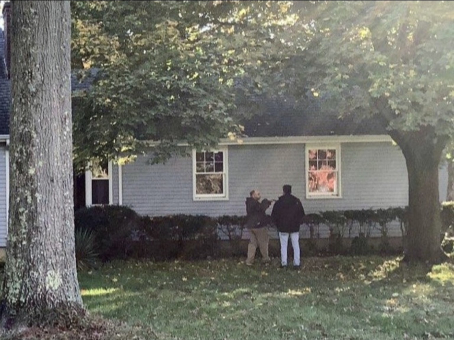 Mike explaining the roofing system to a client during a home inspection